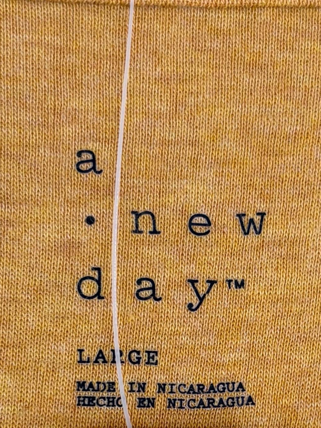 A new day mustard colored long sleeve tee
